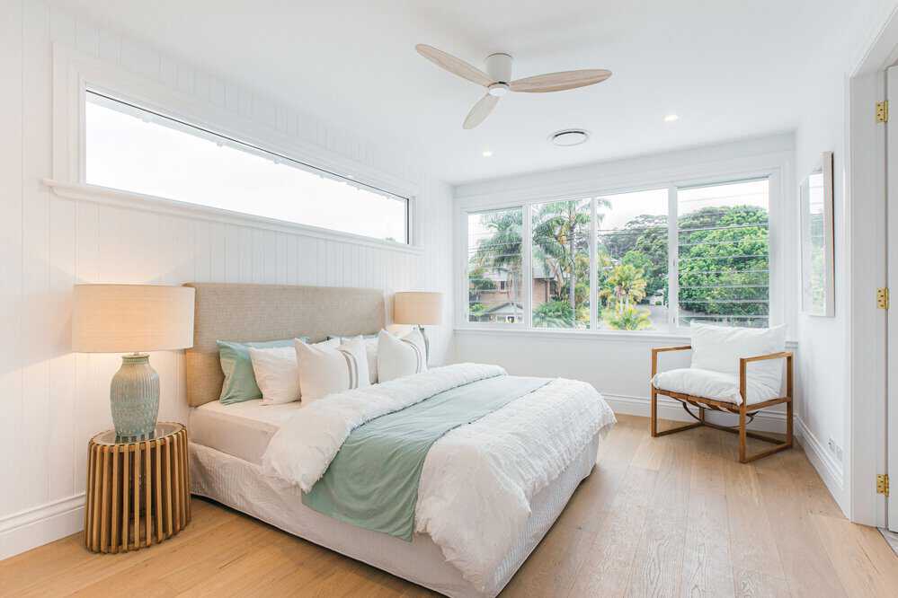 Coastal bedroom with large windows 