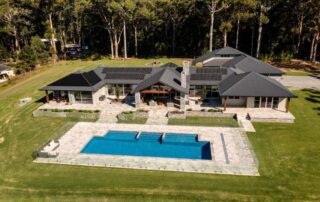 Farmhouse design with timber, stone, and open space.